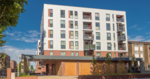 A white apartment block with windows and balconies
