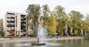 Apartment block with trees, pond and fountain